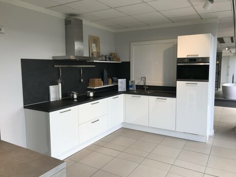 Showroomkeuken Deze sterk afgeprijsde showroomkeuken kun je vinden bij Brugman in Wateringen. Het is een hoek-keuken in de kleur wit en in de stijl modern. Je profiteert nu van 57% korting, waardoor deze keuken al voor € 5195 van jou kan zijn! Heb je interesse in deze keuken of heb je nog vragen? Bel dan gerust naar <a href="tel:0174225850">0174225850</a> of mail naar <a href="mailto:wateringen@brugman.nl">wateringen@brugman.nl</a>. Je kunt ook vrijblijvend een bezichtiging plannen. Brugman keukens en badkamers Wateringen